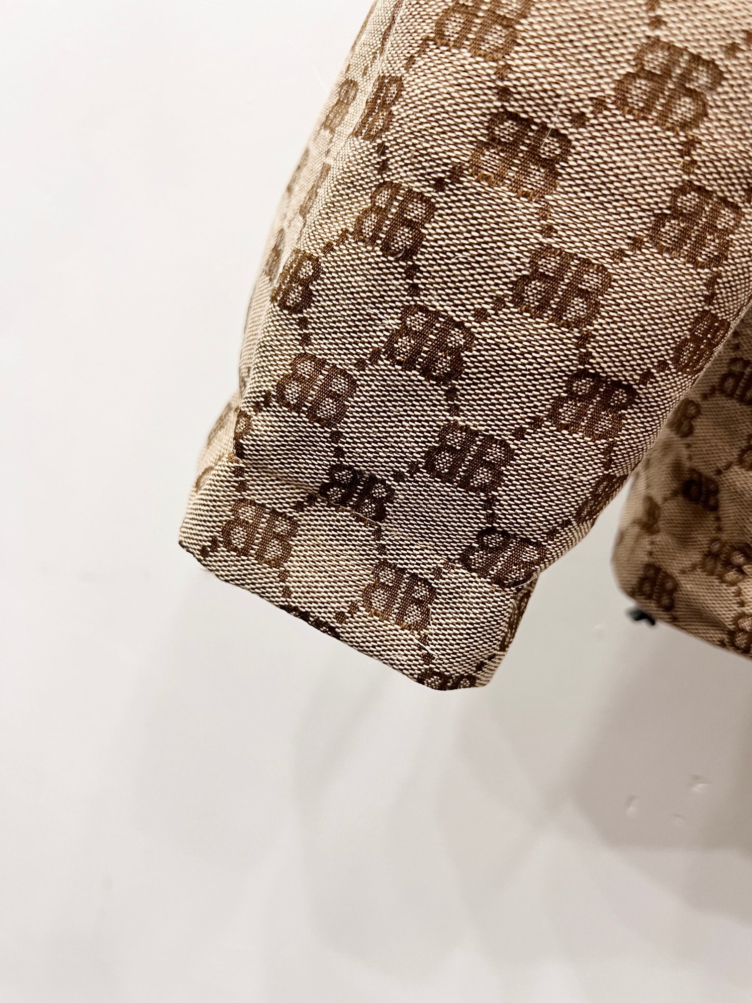 Gucci puffer jacket sleeve end detail in beige monogram fabric