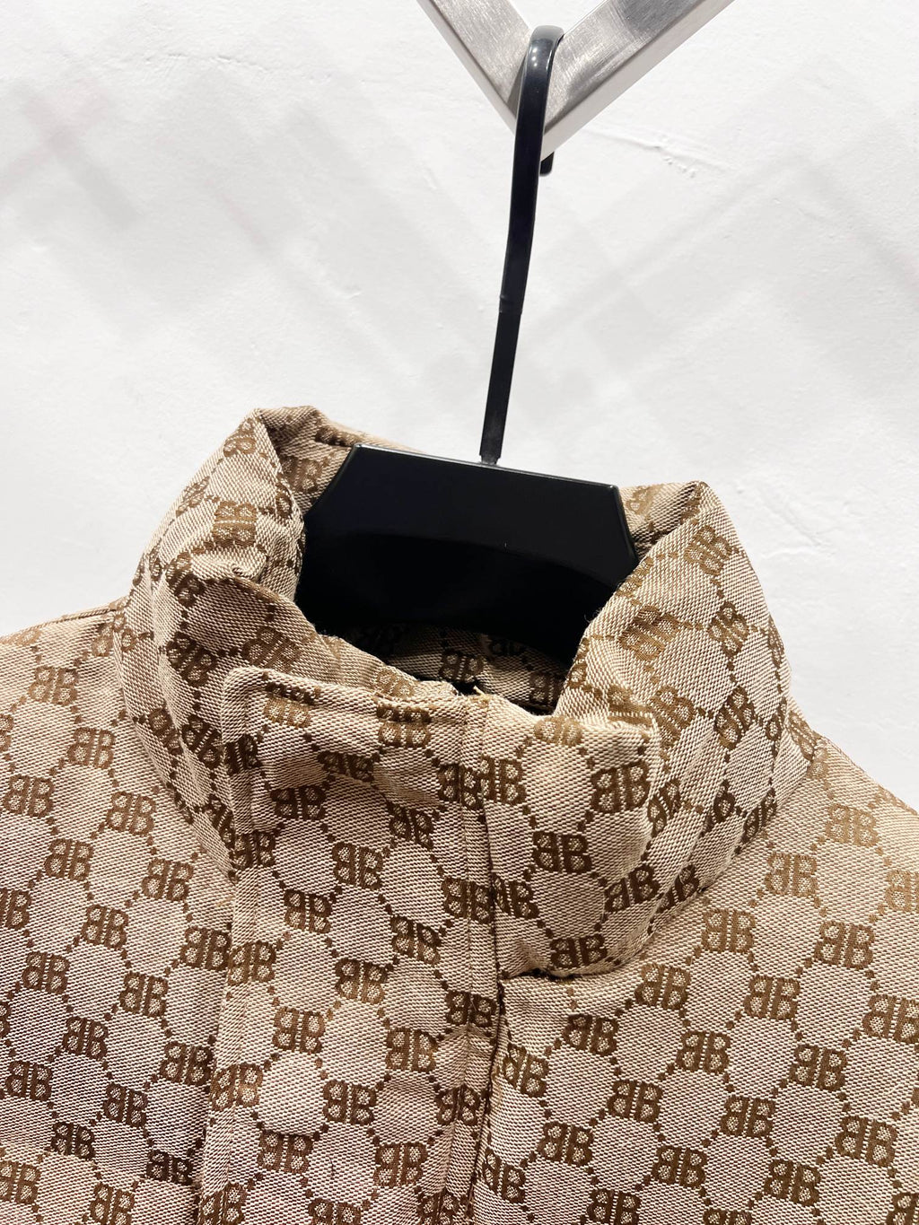 Gucci puffer jacket interior view with beige monogram lining and standing collar