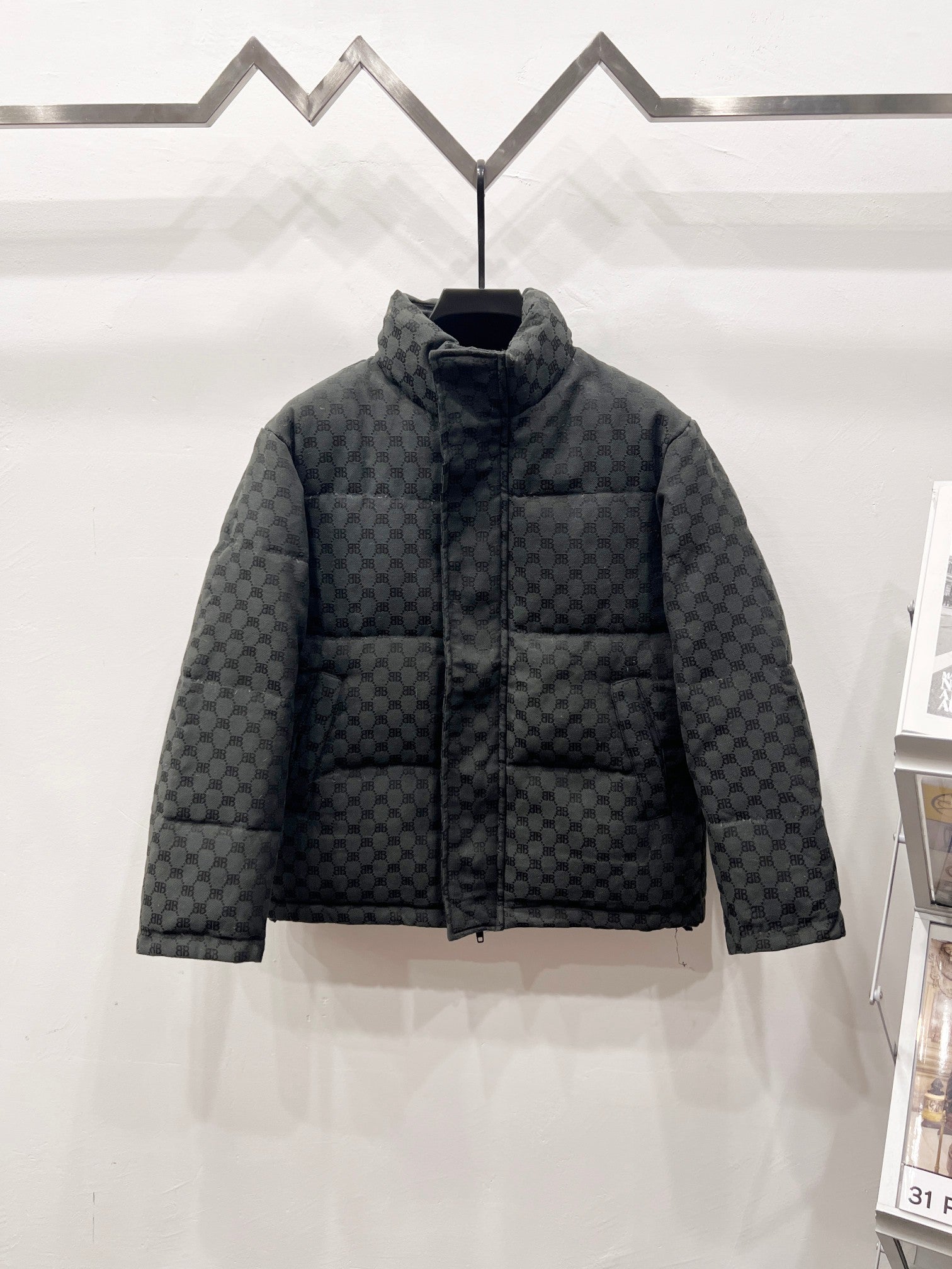Dark gray long puffer jacket with quilted checker monogram pattern and stand collar