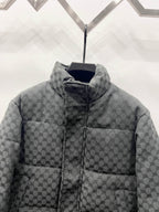 Dark gray long puffer jacket front close-up with zip and quilted monogram stand collar