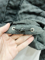 Dark gray puffer jacket with adjustable drawcord hem and metal eyelets