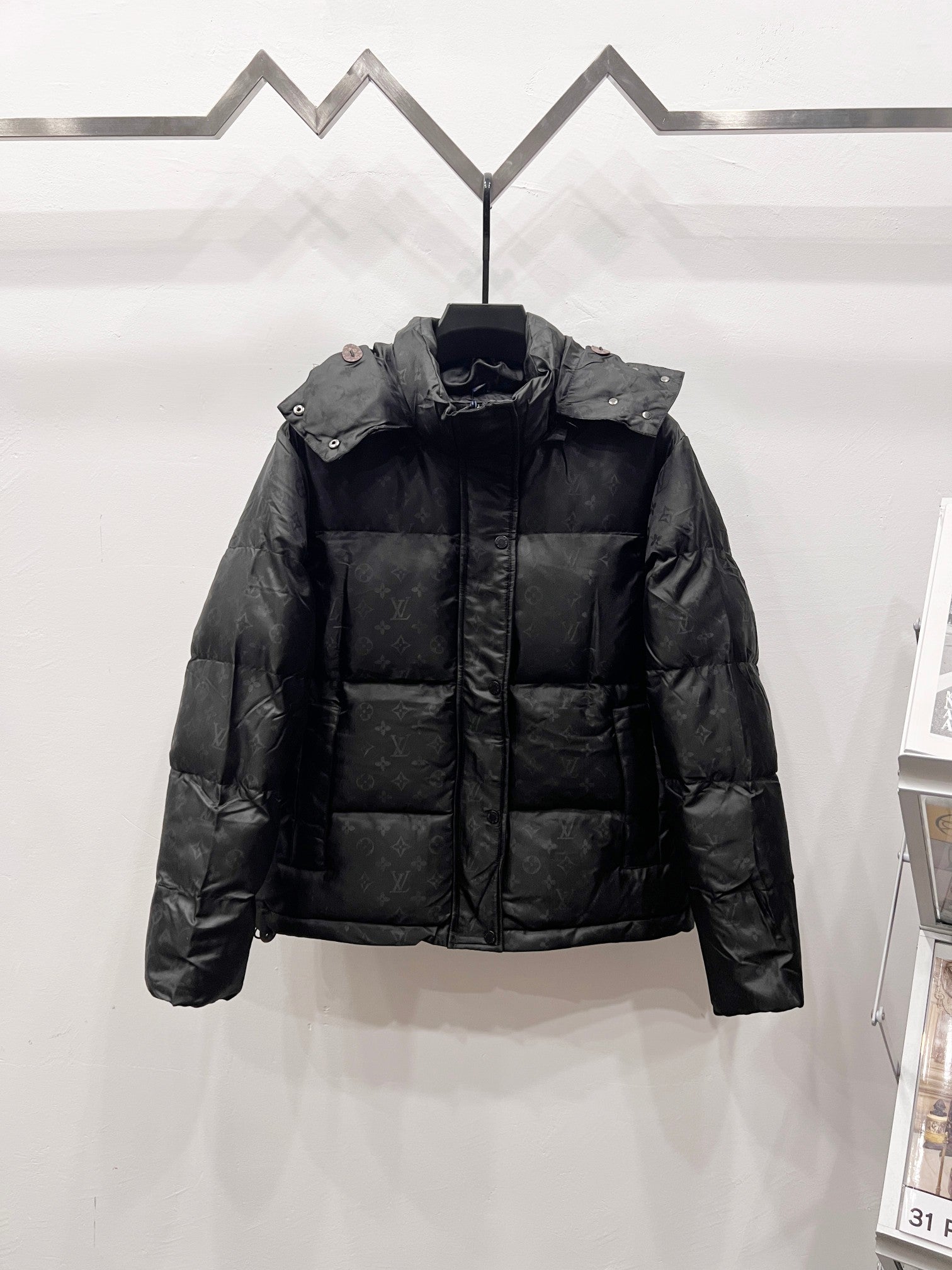 Black long puffer jacket with full-length zipper and padded hood