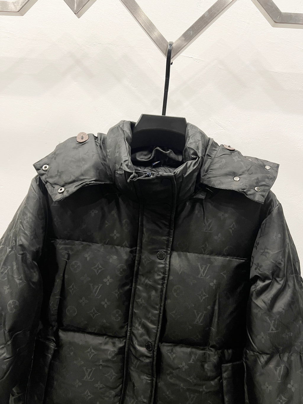Black long puffer jacket with stand collar and buttoned side snaps