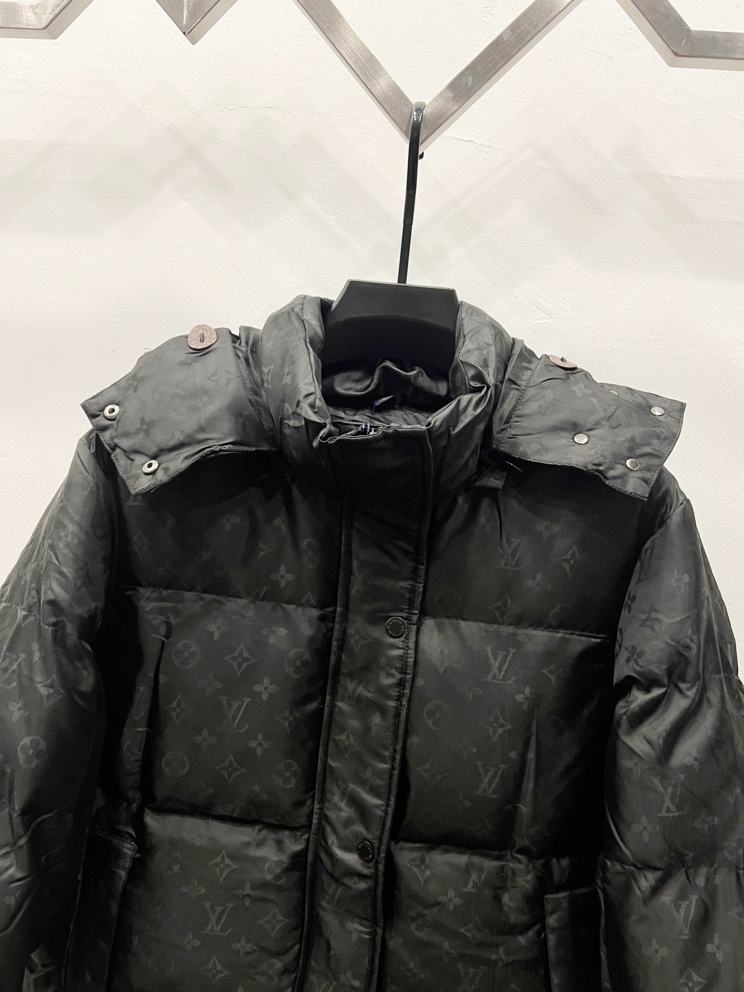 Black long puffer jacket with stand collar and buttoned side snaps