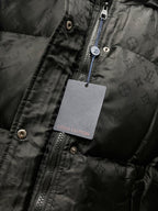 Black puffer jacket zip with Louis Vuitton-branded hanging tag