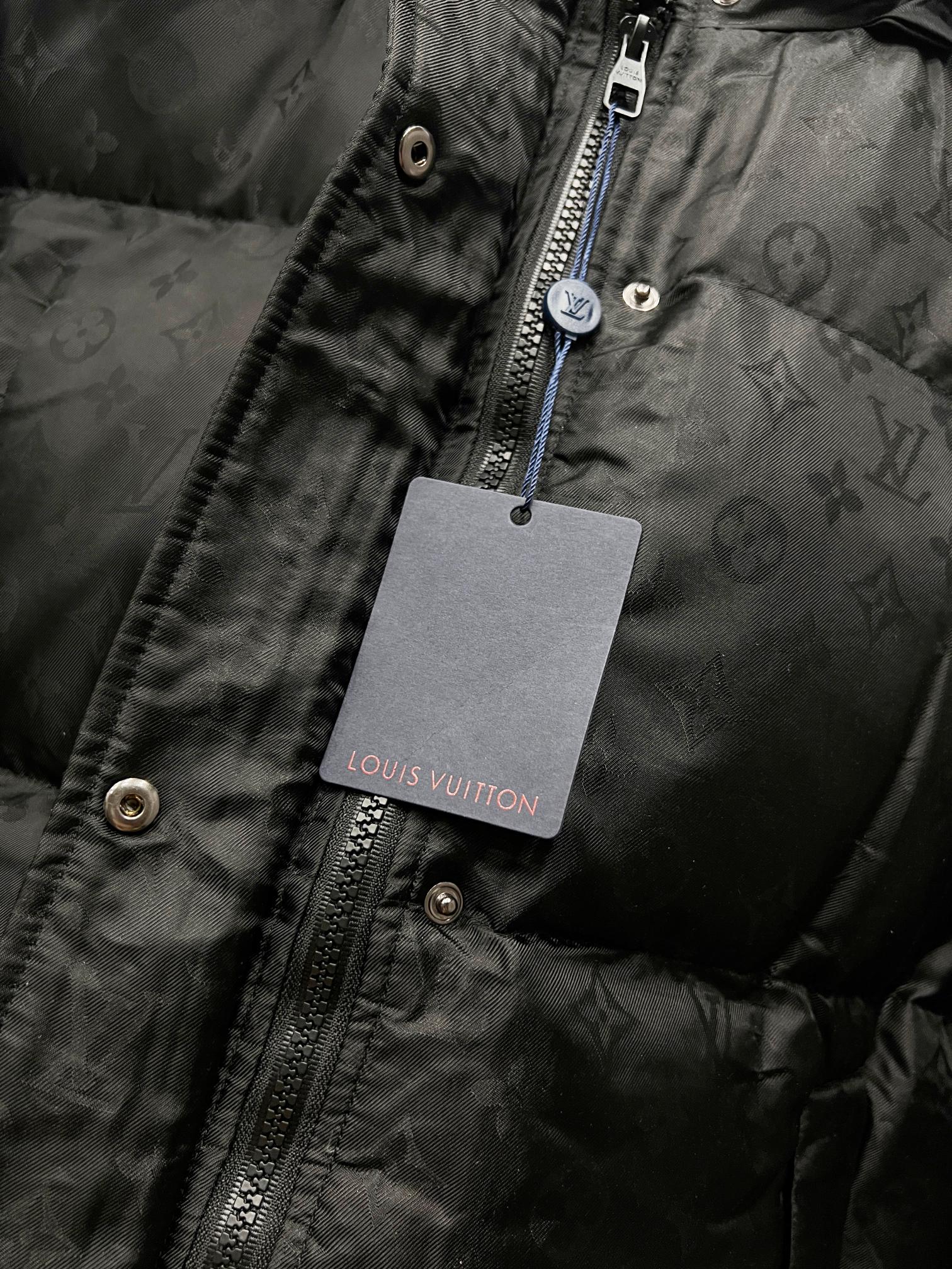 Black puffer jacket zip with Louis Vuitton-branded hanging tag