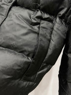 Black puffer jacket with quilted panels and stitched pocket detail