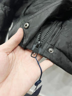 Black hood puffer jacket cuff with zipper pull and adjustable strap