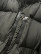 Moncler long puffer jacket zipper with logo pull tab on quilted dark fabric