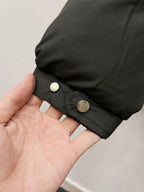 Moncler long puffer jacket cuff with snap button on dark padded sleeve