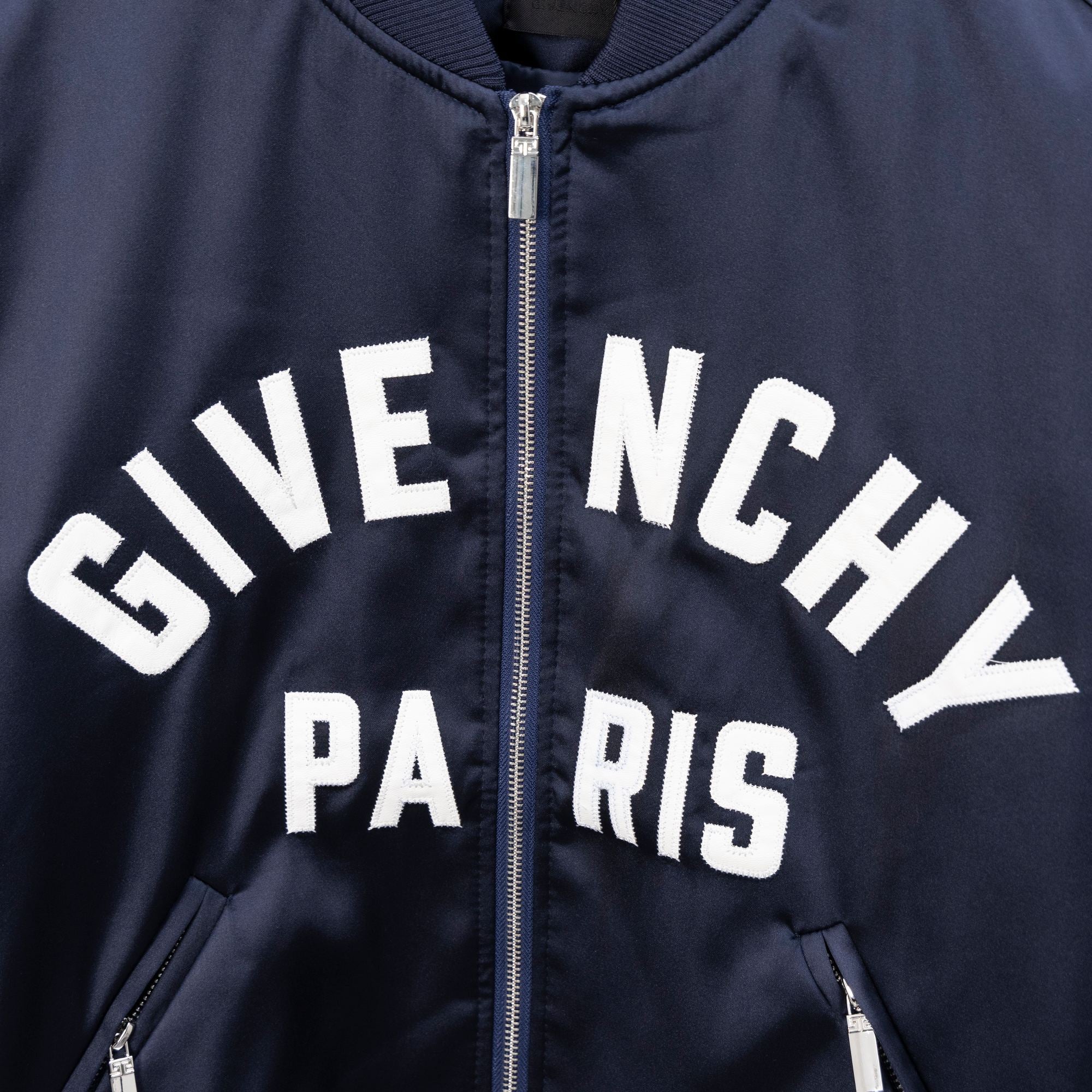 Givenchy bomber jacket logo lettering in white on dark navy front