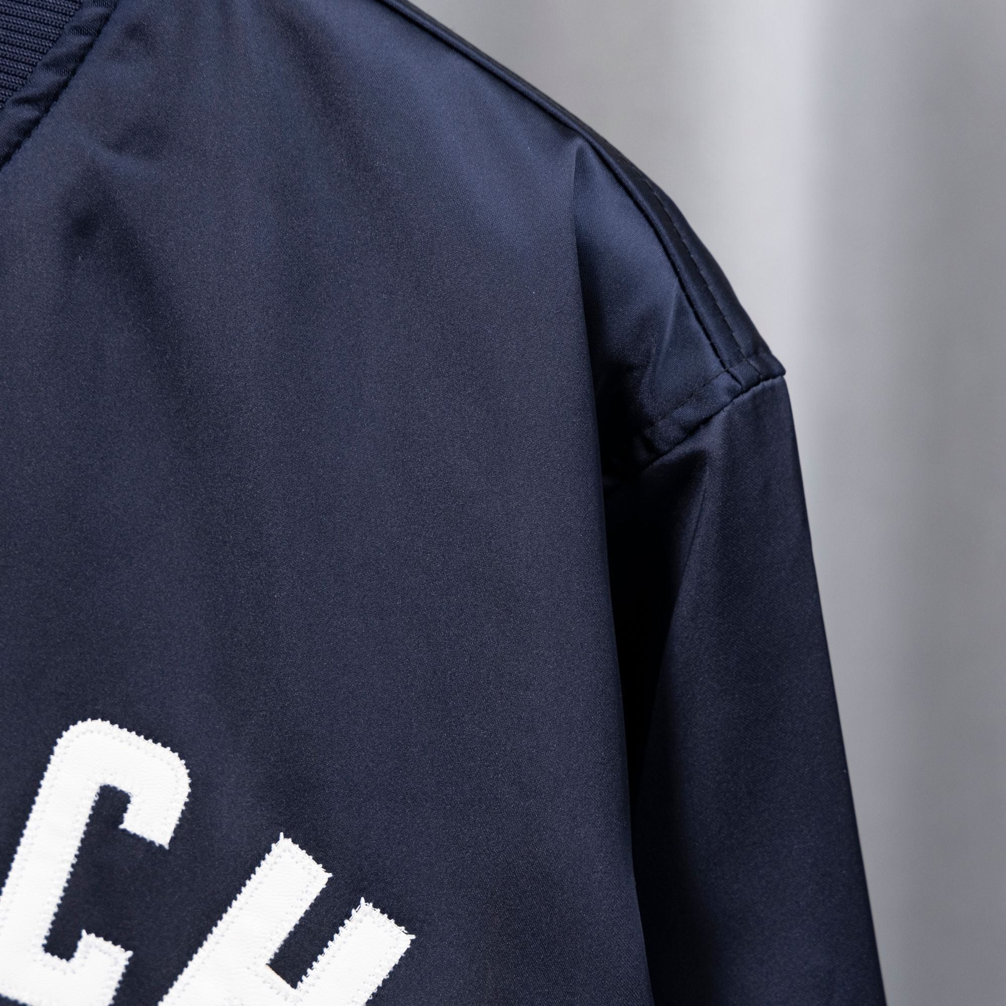 Givenchy dark navy bomber jacket sleeve with smooth satin-like finish