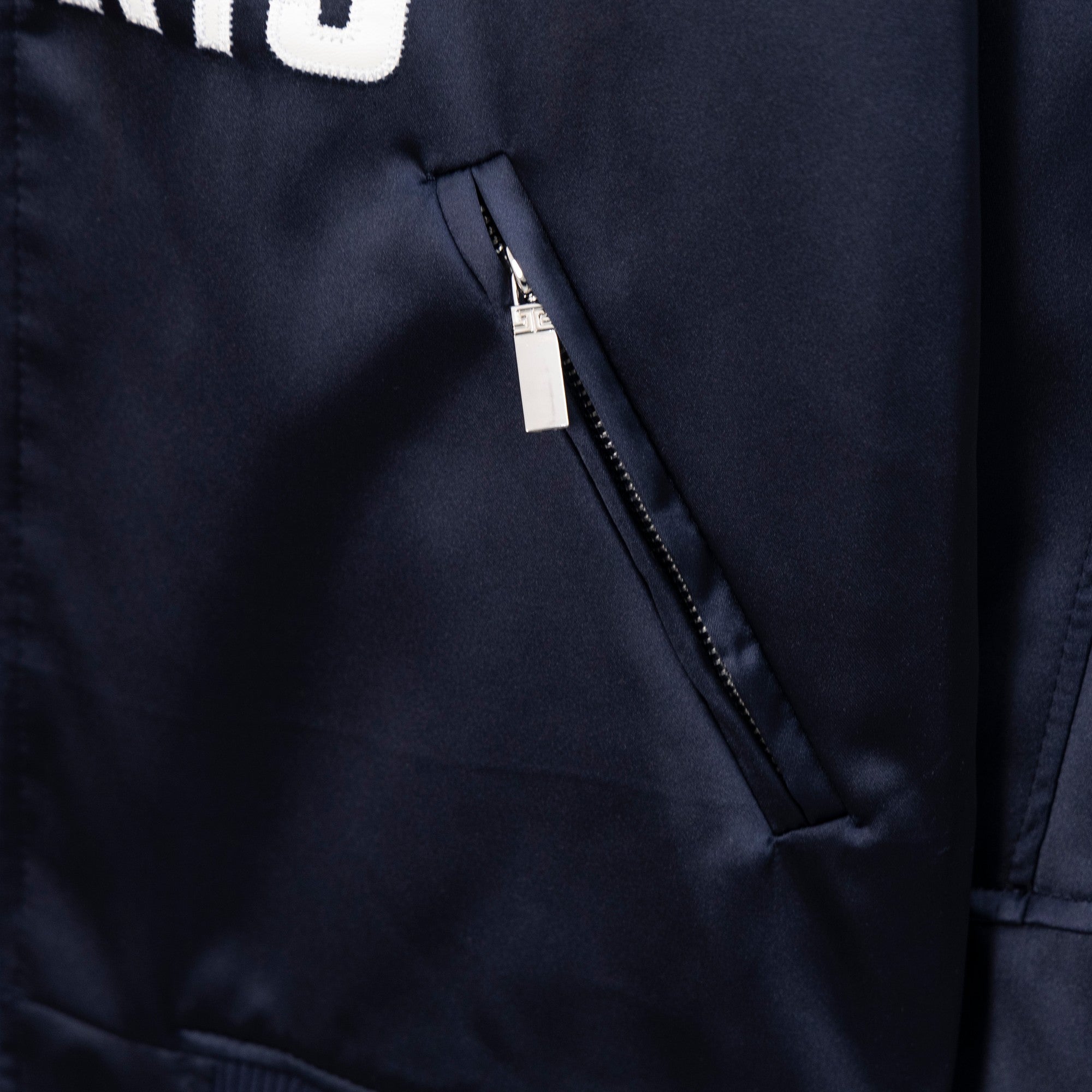 Givenchy bomber jacket side pocket with hidden zip on dark navy fabric