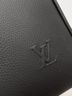 Louis Vuitton logo embossing on grained leather, dark gray.