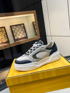 FENDI unisex lace-up sneakers, three-quarter view in white with navy trim and chunky sole