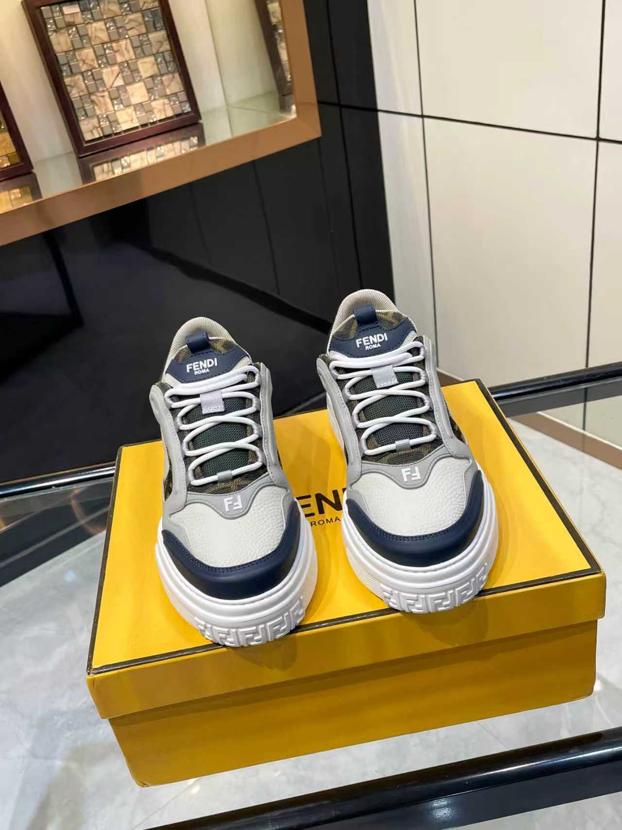 FENDI unisex lace-up sneakers, pair on display with white uppers and navy side panels