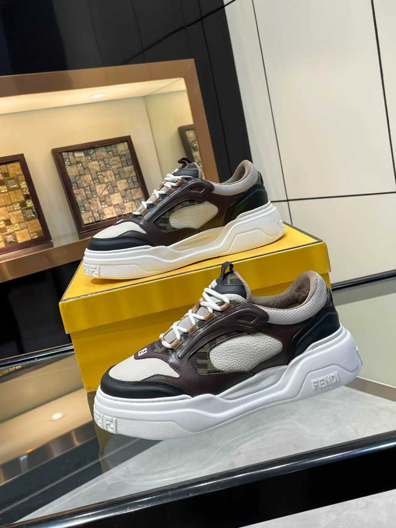 Side view of Fendi unisex chunky lace-up sneakers in black, brown, and gray with white sole