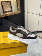 Fendi unisex low-top sneakers with white laces and chunky sole in dark brown and gray