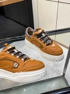 Brown Fendi sneakers, front angle with lace-up straps, gray collar, thick white sole.