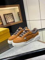 Tan-brown Fendi sneakers with lace-up straps, cushioned collar and thick white sole.
