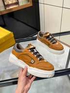 Brown Fendi sneakers shown close, lace-up straps, gray lining and white rubber sole.