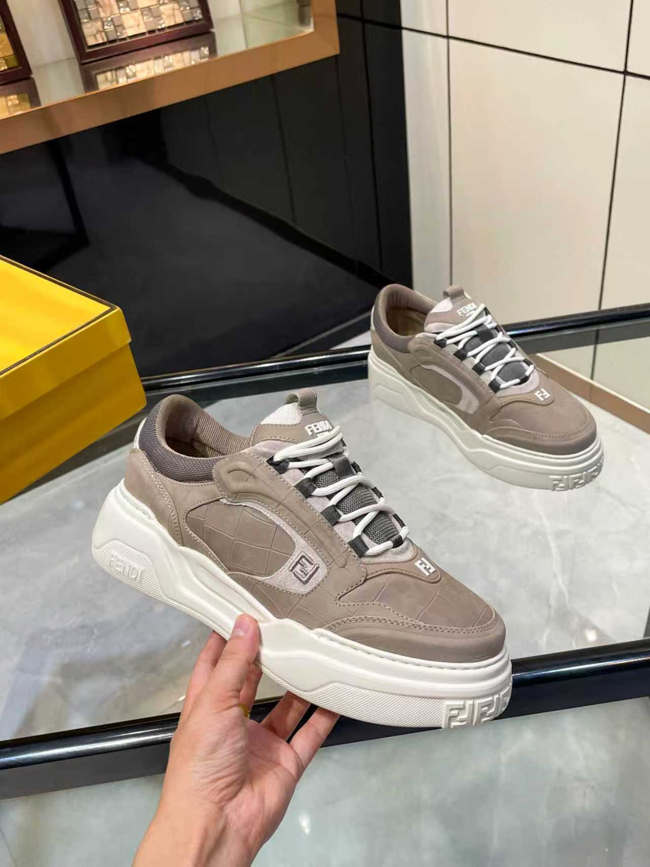 Taupe suede-style Fendi lace-up sneakers with chunky white midsole and embossed logo