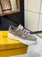 Taupe Fendi lace-up sneakers with thick white sole and side logo patch, side/front view