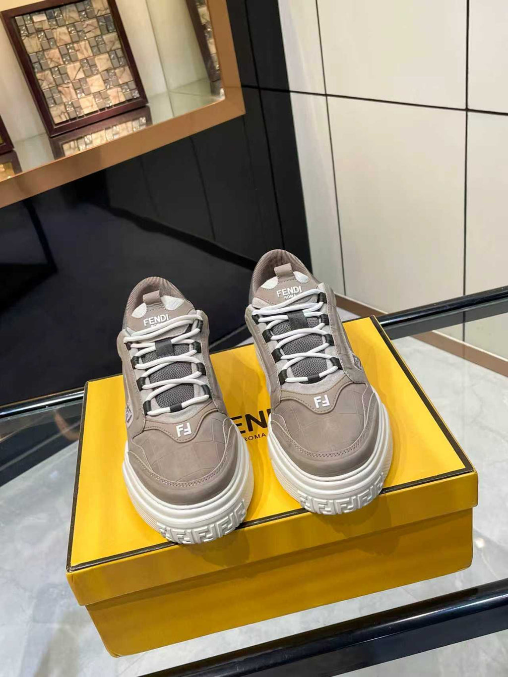 Gray Fendi lace-up sneakers with chunky white sole and F logo on side, unisex style
