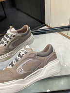 Close-up of taupe Fendi lace-up sneakers showing textured panels, laces, and logo detail