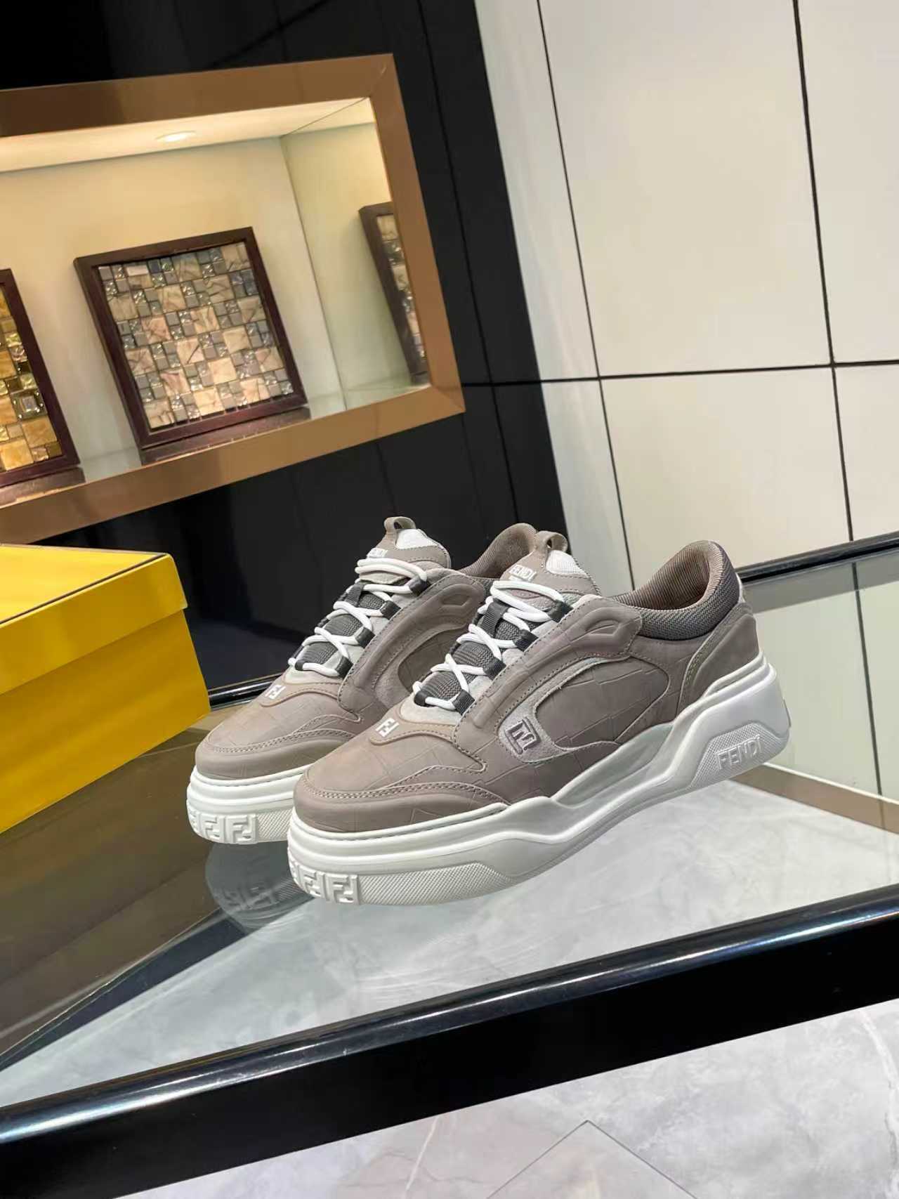 Gray Fendi lace-up sneakers with chunky sole, white accents, and side Fendi emblem