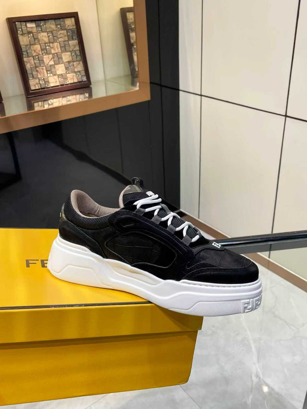 Black lace-up low-top sneakers with white chunky sole and Fendi logo