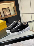 Black lace-up sneakers on white outsole with Fendi logo side details