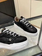 Black lace-up sneakers with white chunky sole, Fendi logo on side and tongue