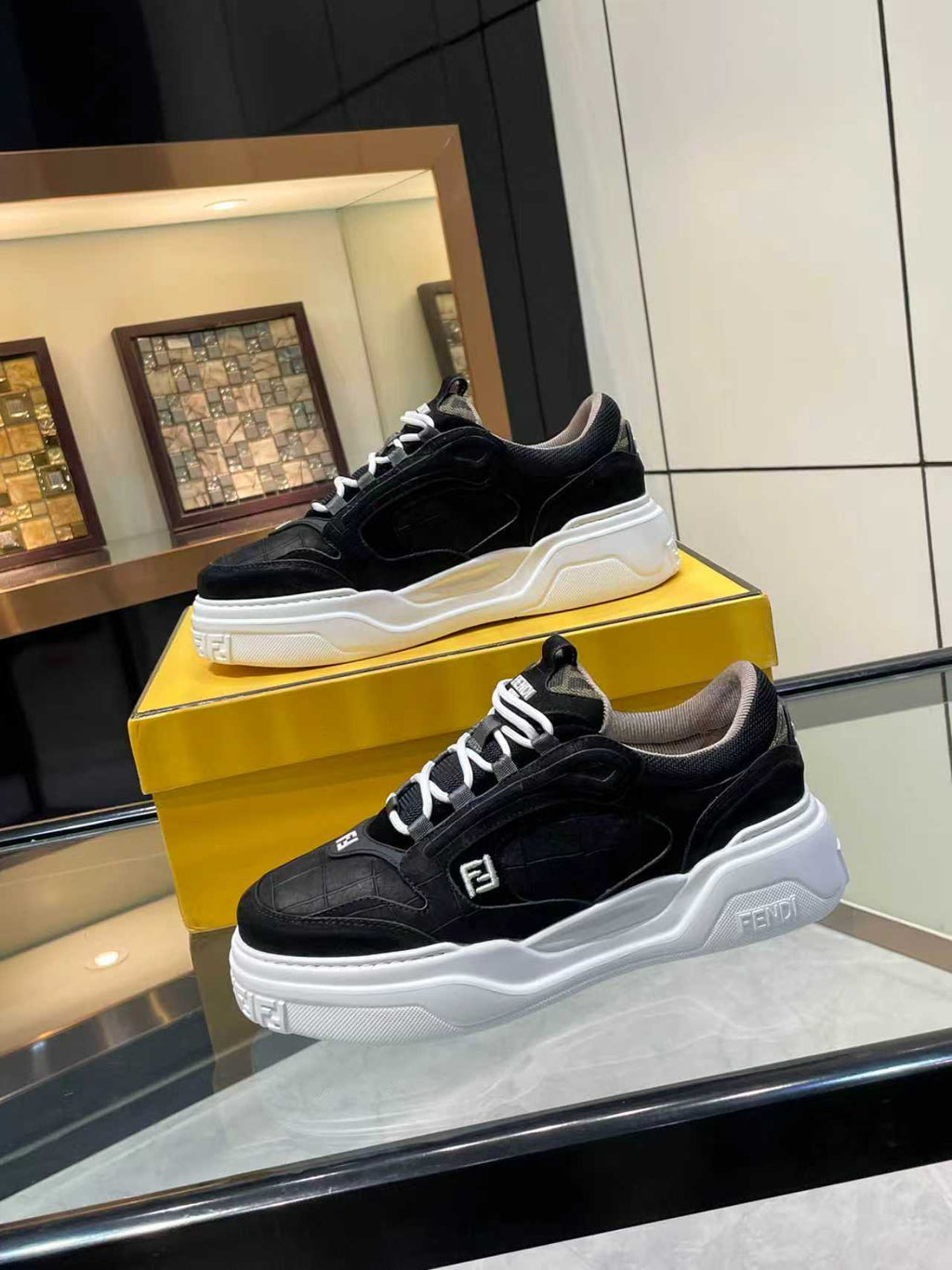 Black lace-up sneakers with white chunky sole and Fendi logo trim