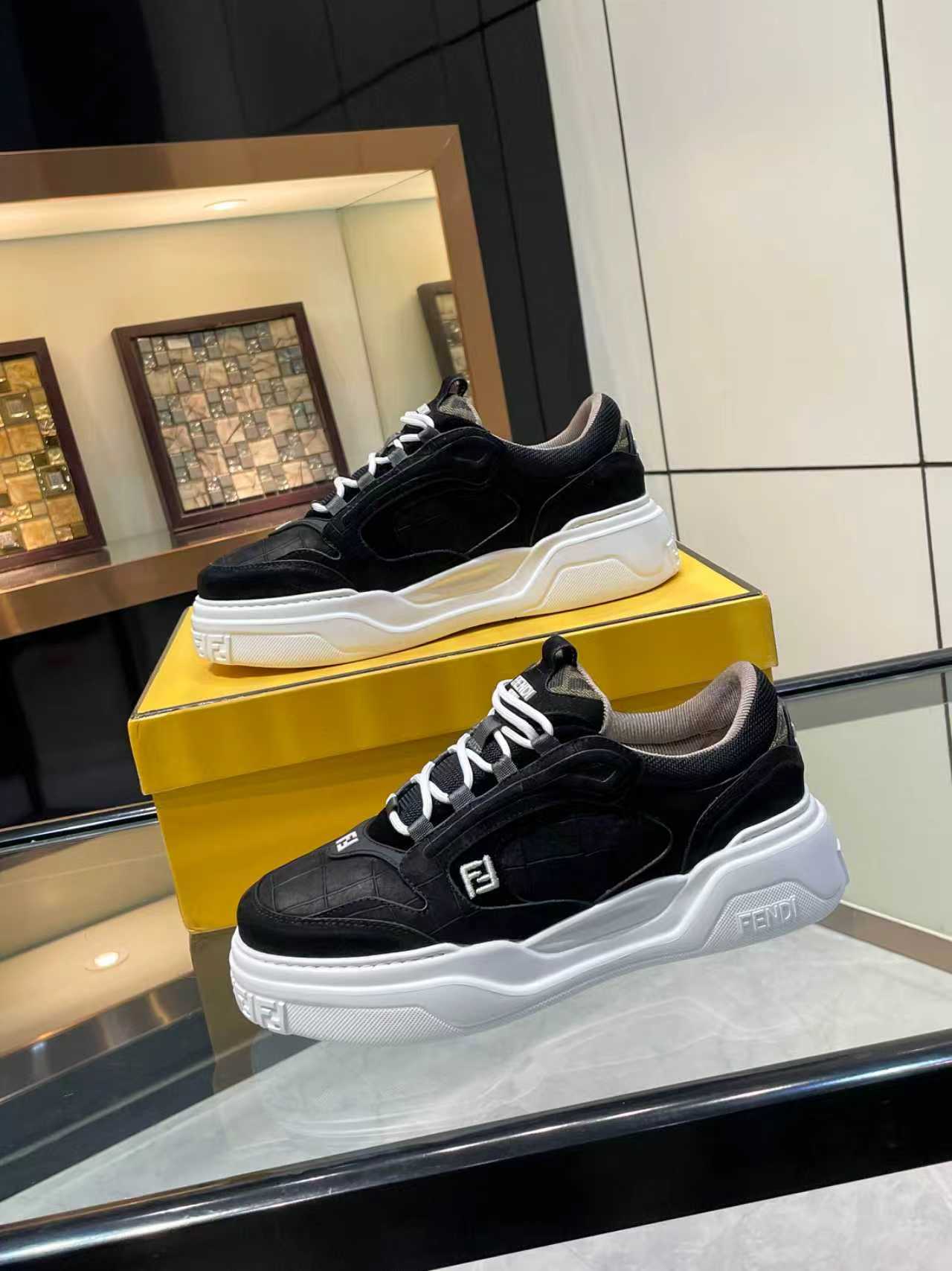 Black lace-up sneakers with white chunky sole and Fendi logo trim