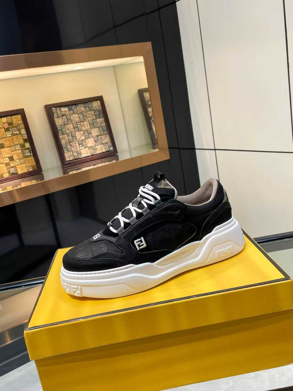 Black lace-up sneakers with white chunky sole and Fendi logo on side