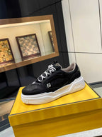 Black lace-up sneakers with white chunky sole and Fendi logo on side