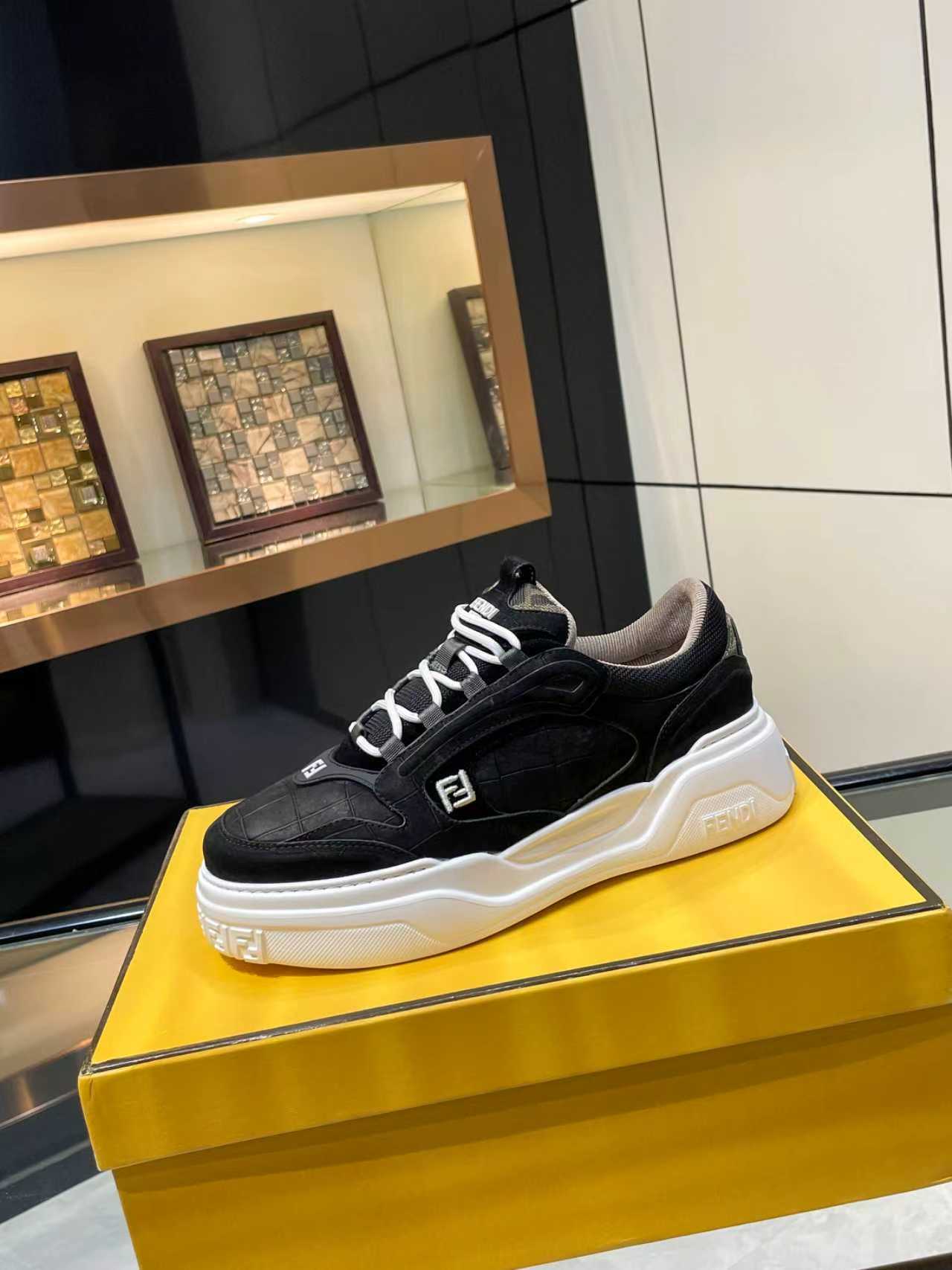 Black lace-up sneakers with white chunky sole and Fendi logo on side