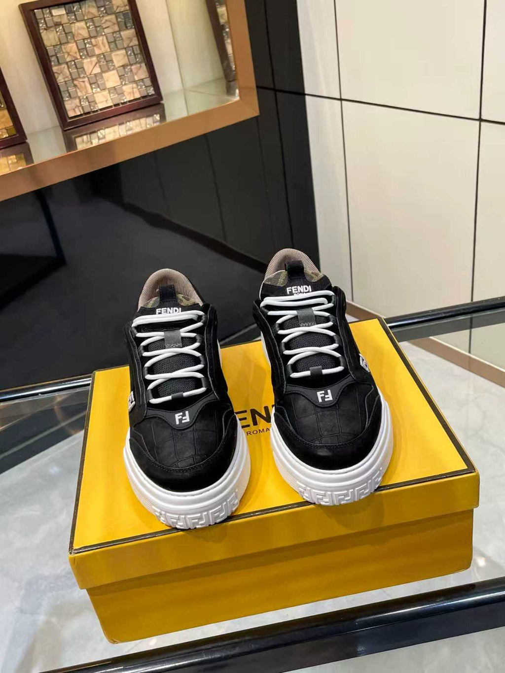 Pair of black lace-up sneakers with white chunky sole and Fendi logo