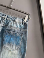 Light blue denim jeans with back pocket and stitched panel details, belt loops
