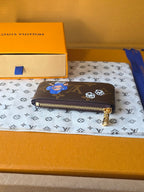 Louis Vuitton small bag side view with gold-tone zipper and monogram leather.