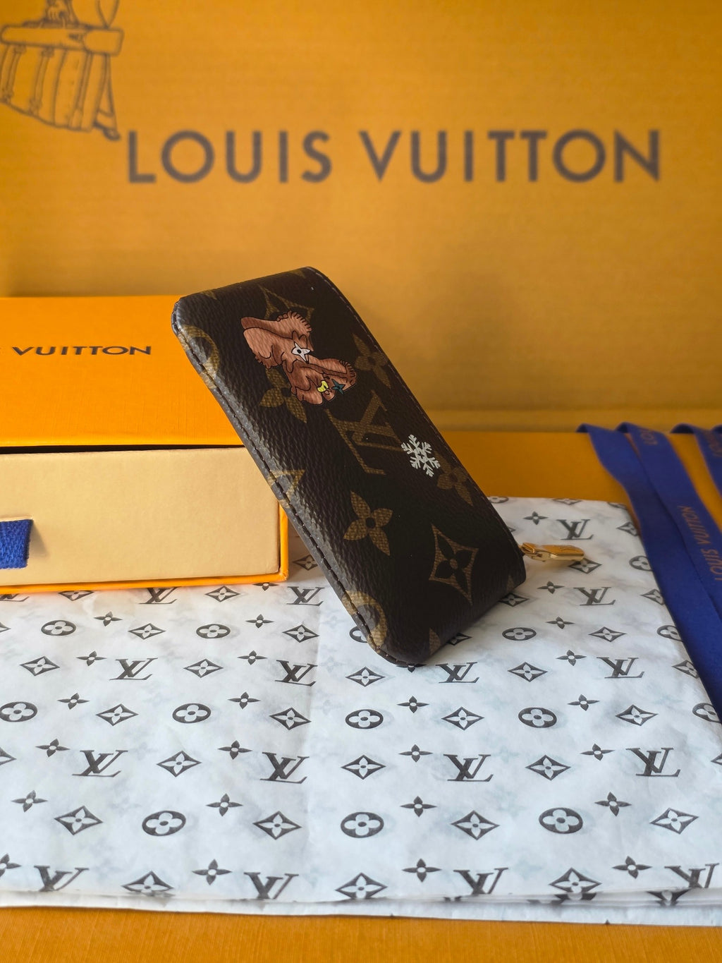Louis Vuitton small bag in dark brown with monogram motifs and gold zipper pull.