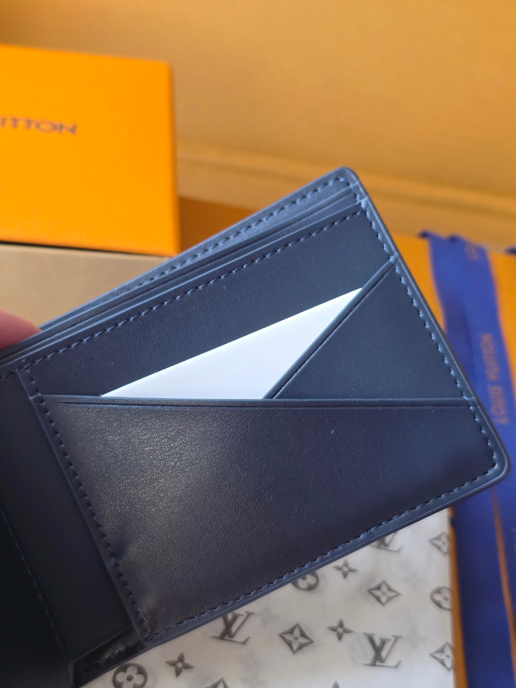 Small bag: Louis Vuitton blue leather card wallet open with card slots visible
