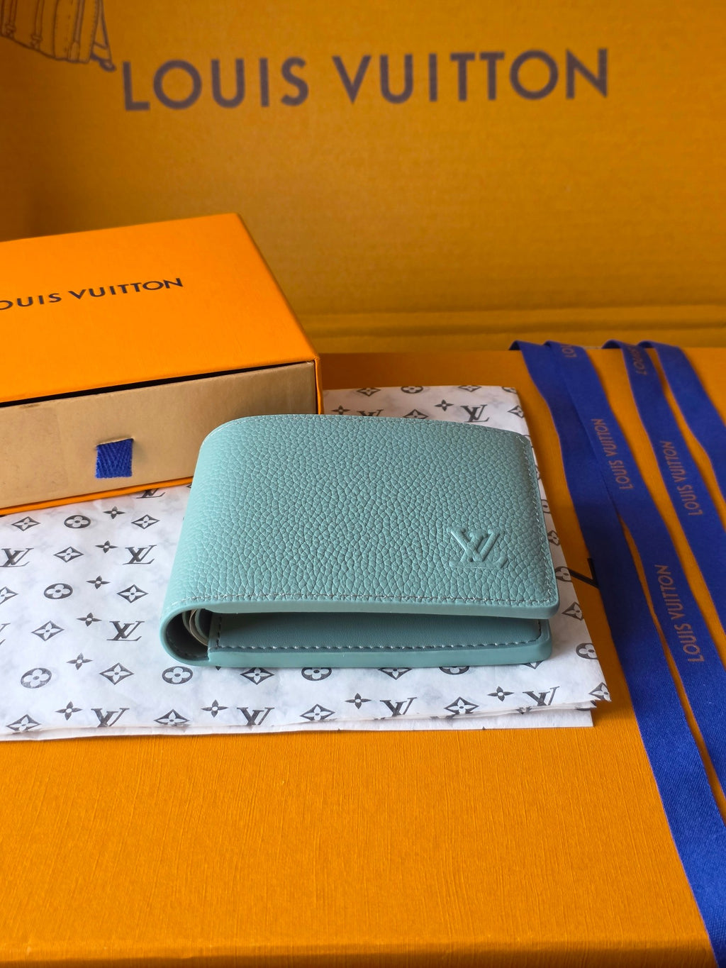 Light blue small bag wallet with flap closure and Louis Vuitton monogram