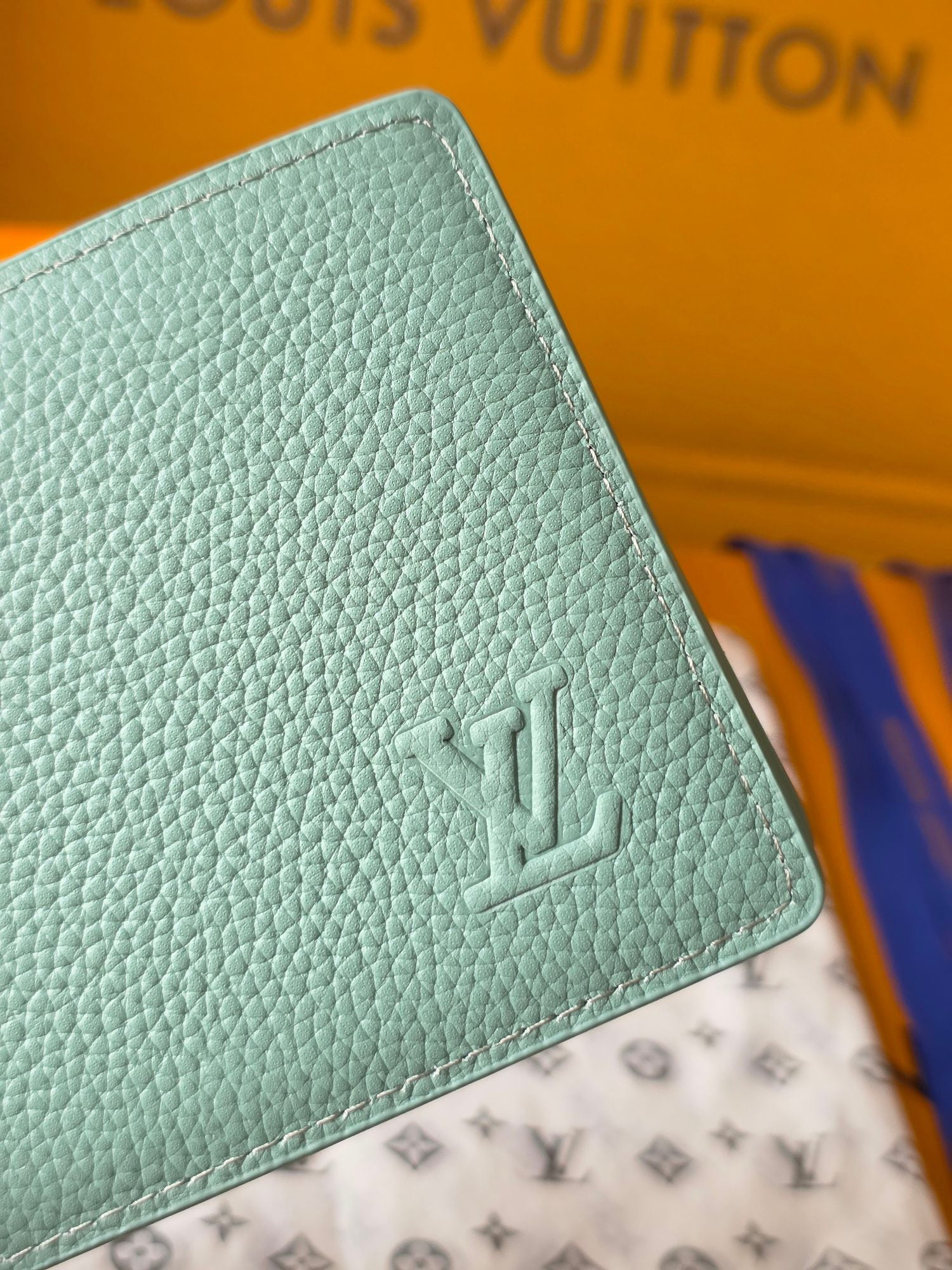 Light blue small bag wallet corner close-up with Louis Vuitton monogram