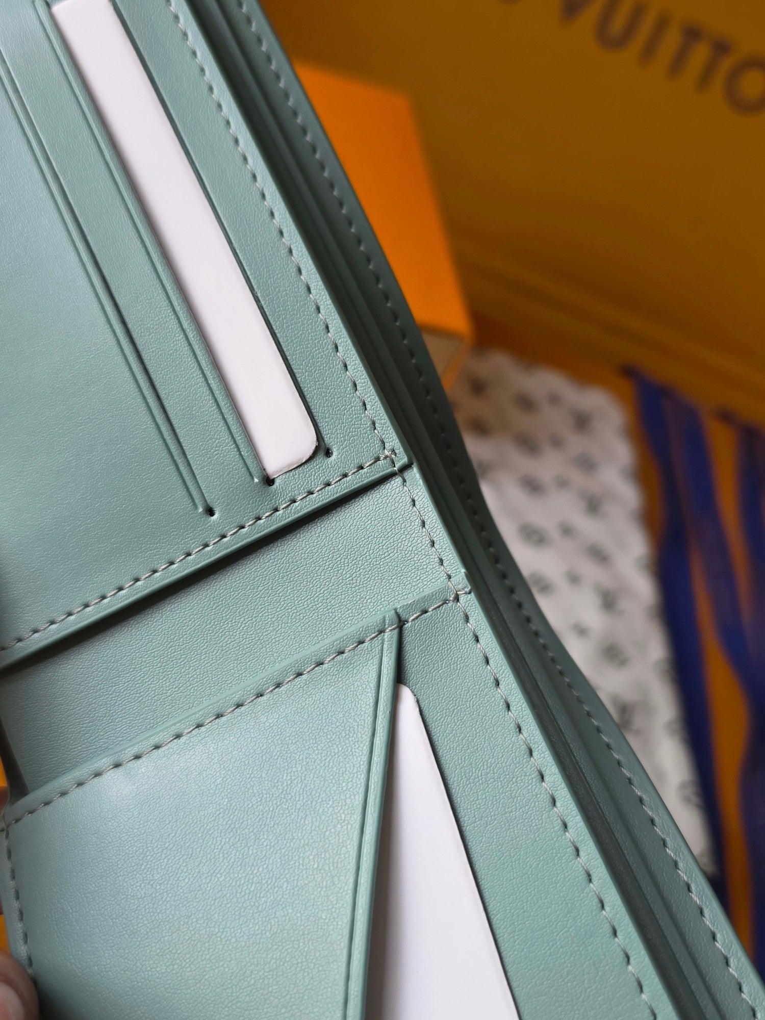 Light blue small bag wallet close-up of side seam and card slot area