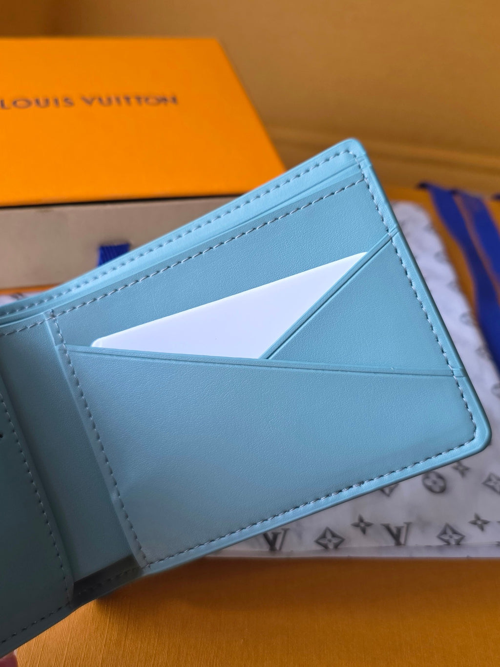 Light blue small bag wallet open showing card slot window
