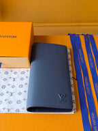 Small leather wallet with dark blue pebbled finish and open interior pocket