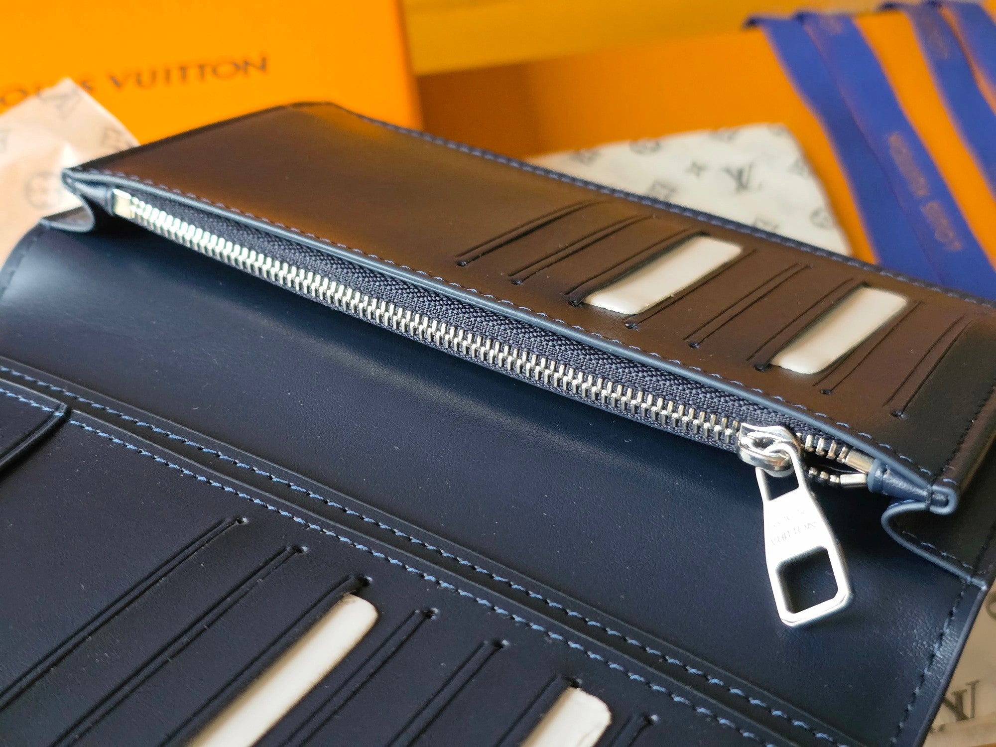 Small leather wallet interior close-up with card slots and zippered compartment