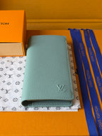 Light blue leather small bag with Louis Vuitton emblem and snap closure